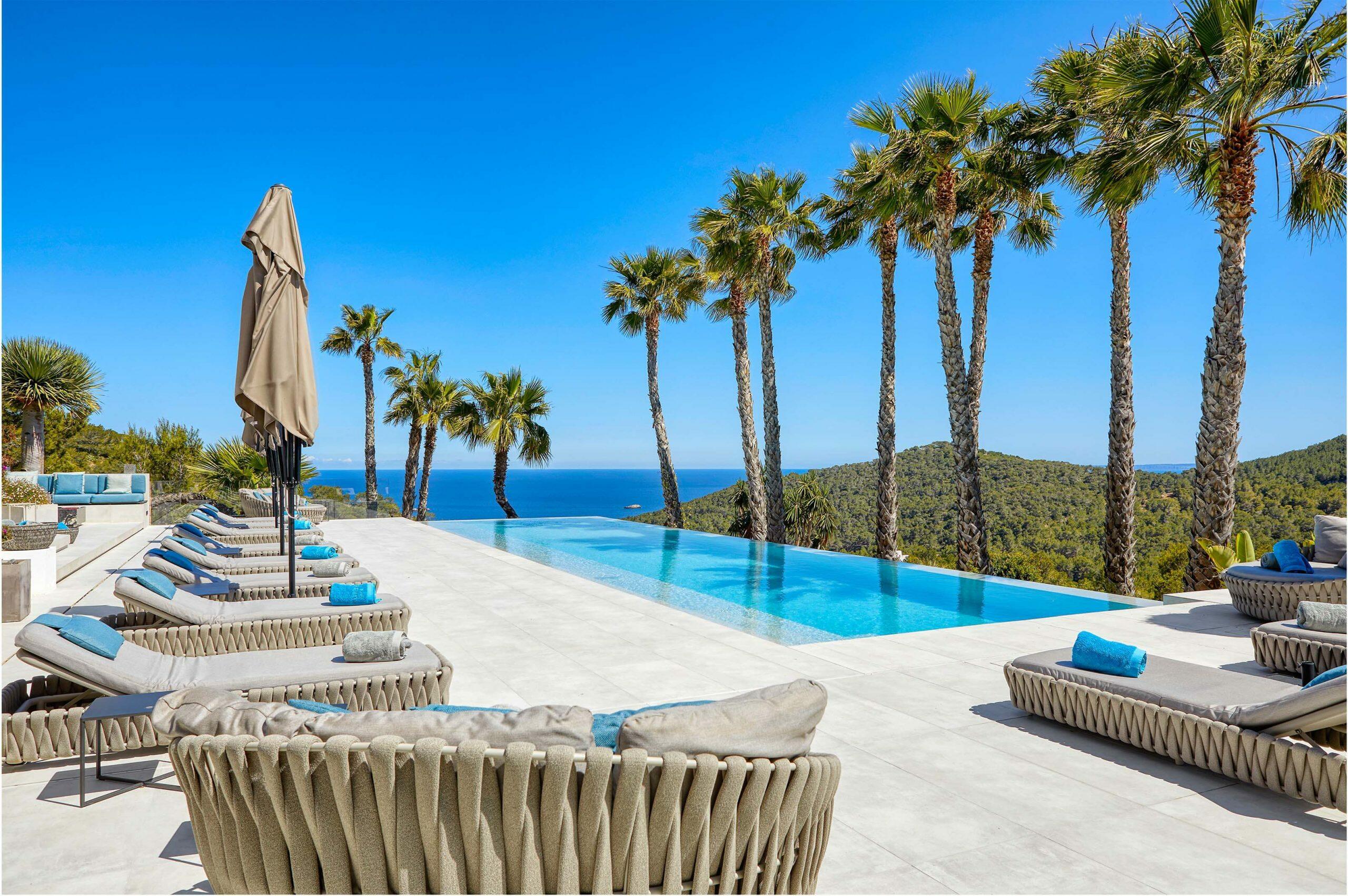 Poolside view of a properties in Ibiza . Learn how to diversify your portfolio with luxury properties, strong returns, and lifestyle perks. in Ibiza.